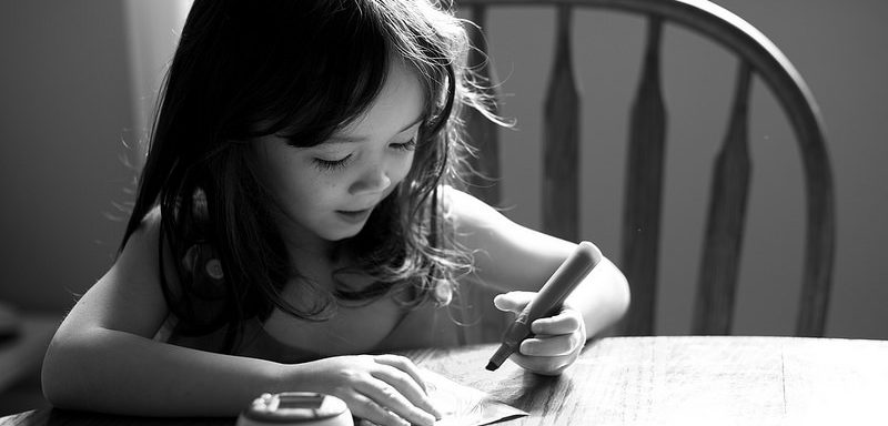 young child writing to illustrate reclaiming our creativity in a blogpost by Yang-May Ooi